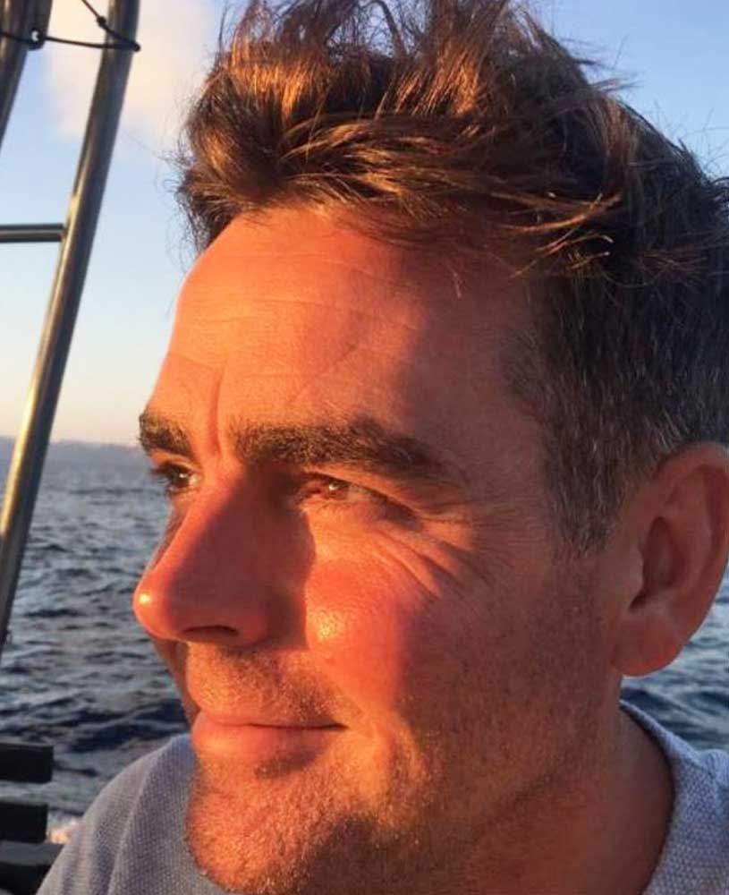Ashes Jewellery AE owner on a boat with water and sky in the background